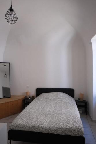 a bedroom with a bed and a flat screen tv at Les Vans Centre-village in Les Vans