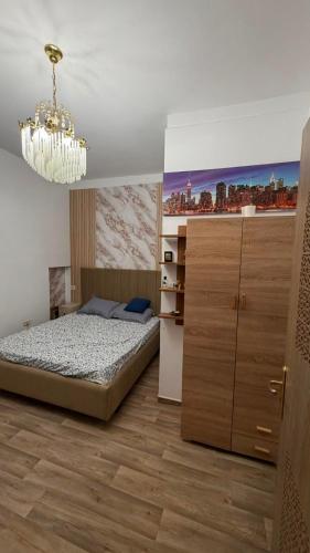 a bedroom with a bed and a chandelier at Nouira Haus in Akouda