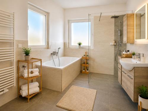 a bathroom with a tub and a sink at Ena Appartements in Altenmarkt im Pongau