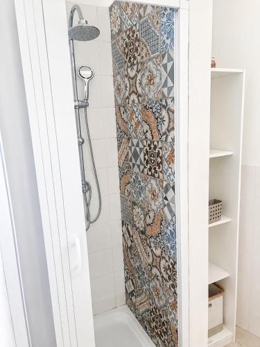 a shower in a bathroom with a mosaic wall at Le case di Rebecca in Palermo