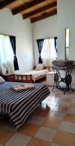 a room with two beds and a table in it at La Ricarda in Gualeguaychú