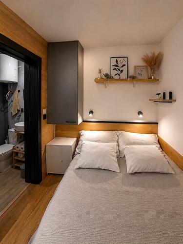 a bedroom with a large bed with white pillows at Panorama House in Bartolovci