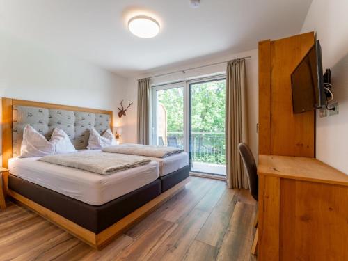 a hotel room with two beds and a television at Bergblick in Werfenweng