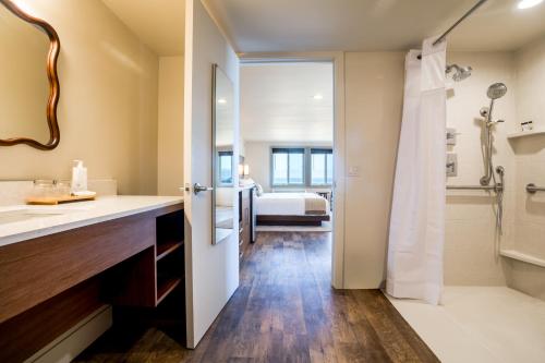 a bathroom with a sink and a shower at Manzanita Oceanfront Inn in Manzanita