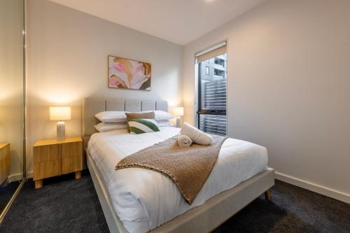a bedroom with a large bed and a window at Bentleigh & Beyond Your Melbourne Getaway in Melbourne