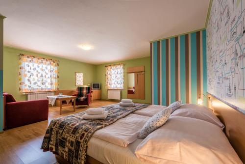 a large bed in a room with green walls at Penzion Eso in Martin