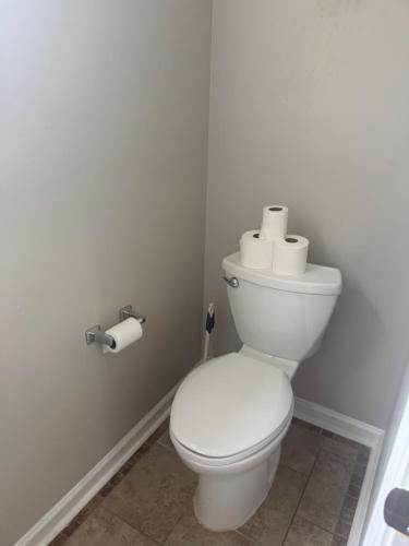 a bathroom with a toilet with two rolls of toilet paper at Stone Homes in Lawrenceville