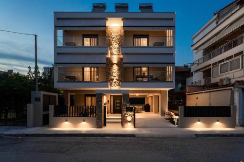 a tall building with lights on the side of it at AKSQUARED Premium Vacation Apartments in Paralia Dionysiou