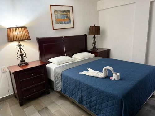a bedroom with a bed with a swan on it at Hotel Vahuma in Monterrey