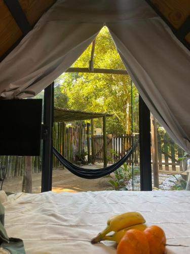 a bed with bananas and oranges on top of it at Cabana recanto da TOCA in Ilhabela