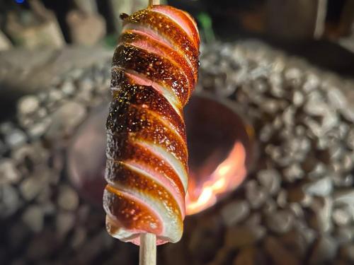 a stick with a sausage on top at Cabana recanto da TOCA in Ilhabela