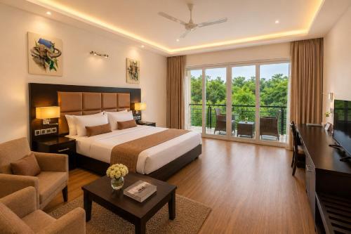 a hotel room with a bed and a television at Cassandra Culture Resort in Sigiriya