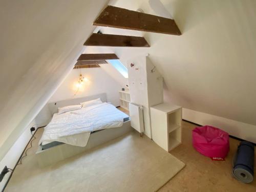 a small bedroom with a bed in a attic at AHOI-MARIE in Blekendorf