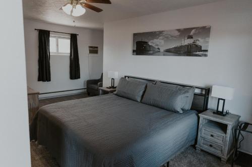 a bedroom with a bed and a ceiling fan at The Last Resort in Sault Ste. Marie