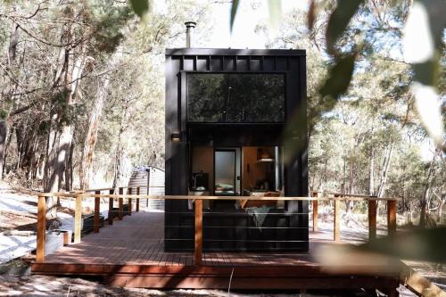 a black tiny house in the woods at SHAK Halls Gap - Off Grid Tiny Home in Halls Gap