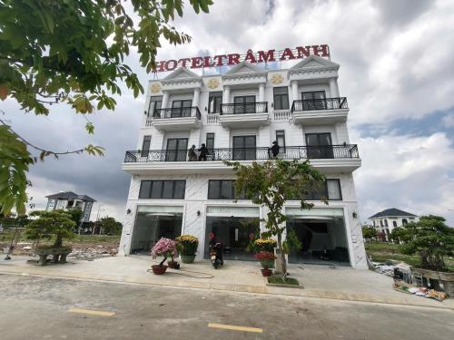 a white building with a sign on top of it at Hotel Trâm Anh 3 in Nhơn Trạch
