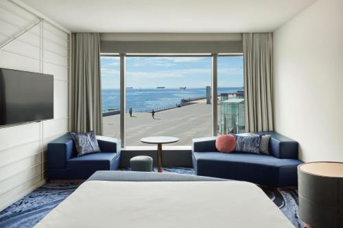 a hotel room with a bed and a view of the ocean at W Barcelona in Barcelona