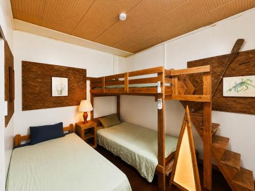 two beds in a room with two bunk beds at おきなわ民泊海族 in Okinawa City
