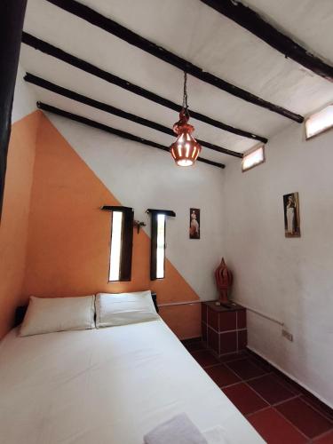 a bedroom with a large white bed in a room at Cabañas Cañon Del Chicamocha in Aratoca