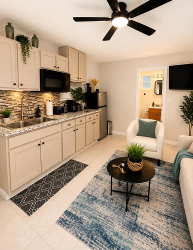 a kitchen and living room with a couch and a table at The Arlington Hideaway in Jacksonville