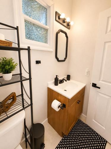 a bathroom with a sink and a mirror at The Arlington Hideaway in Jacksonville