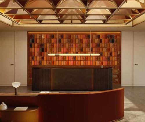a lobby with a counter and a wall of books at DoubleTree by Hilton Madrid Principe de Vergara in Madrid