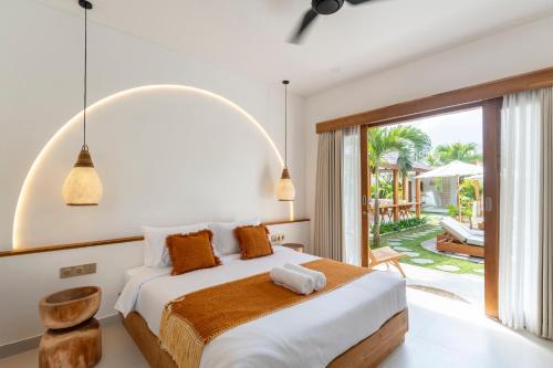 a bedroom with a bed and a large window at SUMA Bali in Uluwatu