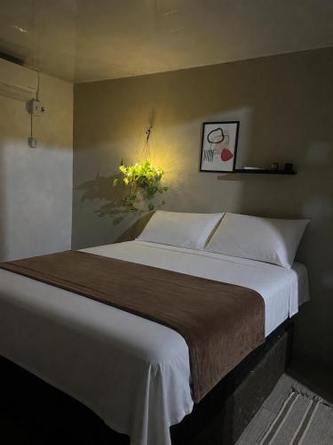 a bedroom with a large bed with white sheets at Casa Maré in Soure