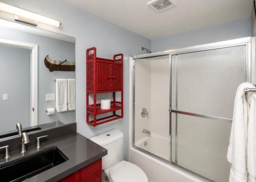 a bathroom with a shower and a toilet and a sink at RIVERFRONT RUBY RED HOME WITH PRIVATE DOCK & View in Bullhead City