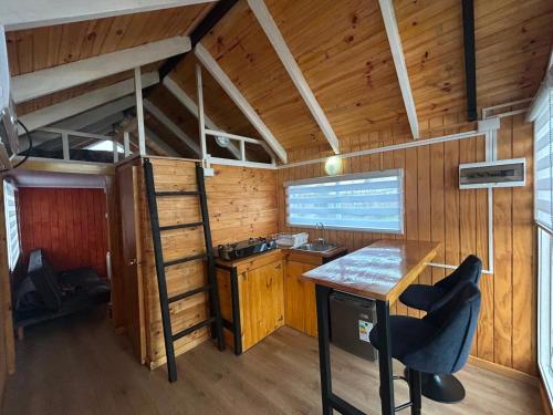 a kitchen with a desk and a bunk bed in a room at Dyl Tiny House con Jacuzzi in Puerto Montt