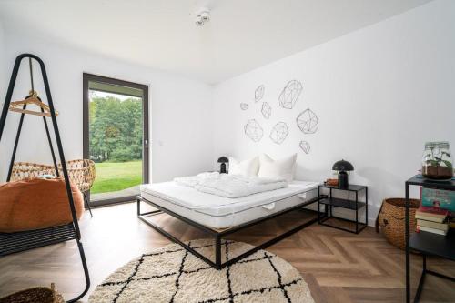 a white room with a bed and a window at Ferienwohnung-Cleo in Mirow