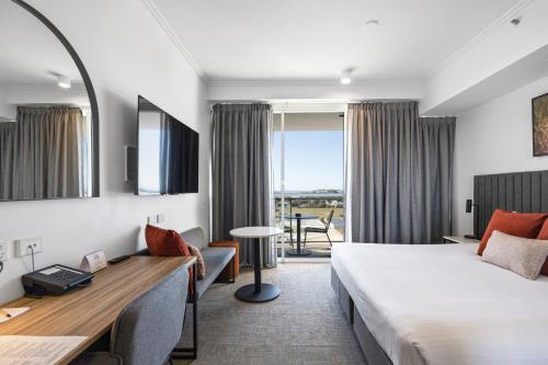 a hotel room with a bed and a desk at Quest Mackay on Gordon in Mackay