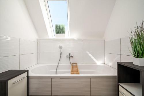 a bath tub in a bathroom with a window at Ferienwohung-Liv-OG in Rechlin