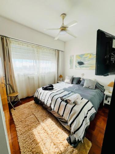 a bedroom with a large bed with a rug at Departamento chic centro 2 habitaciones in Mendoza