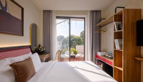 a hotel room with a bed and a balcony at LoverA Signature Hotel in Ho Chi Minh City