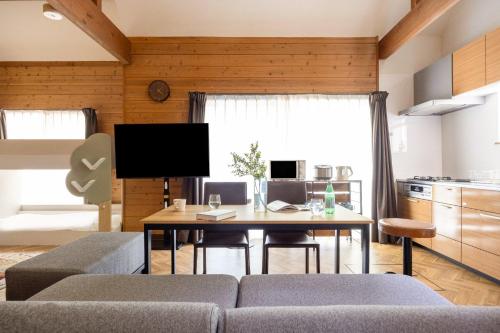 a living room with a couch and a table at S-villa Nasu 4th in Nasu