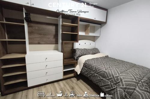 a bedroom with a bed and a dresser at Moderno Departamnto 3 dormitorios in Moquegua