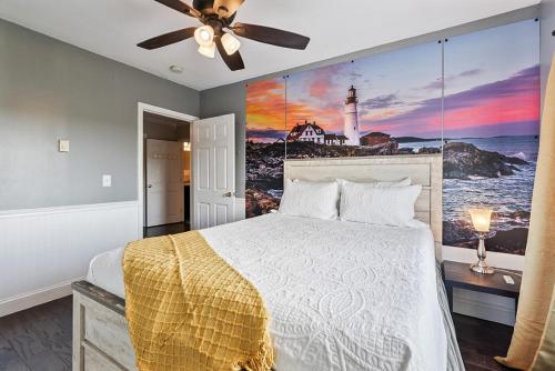a bedroom with a bed with a lighthouse mural on the wall at Country Style Home 4br 2bth in Brewer