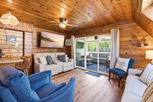 a living room with wooden walls and a ceiling at Chalet #57 in Stevensville
