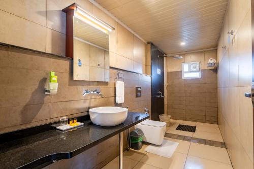 a bathroom with a sink and a toilet at Falcon Crest in Vagamon