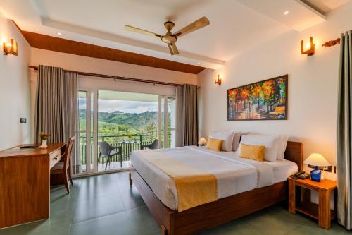 a bedroom with a large bed and a balcony at Falcon Crest in Vagamon