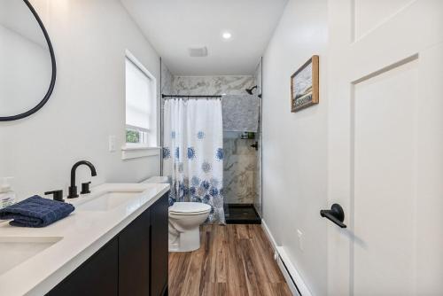 a white bathroom with a toilet and a sink at New Riverside Fire Pit 3BR 2.5 bath in Brewer