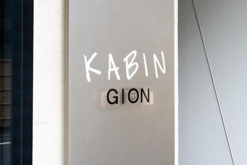 a sign on a door with the wordkarma clan at KABIN Gion in Kyoto