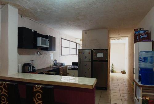 a kitchen with a refrigerator and a counter top at Amueblados Casa Conchita in León