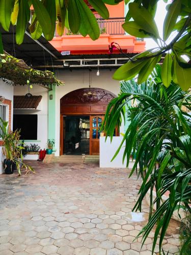 an entrance to a building with a brick courtyard at Phum Angkor in Siem Reap
