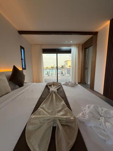 a bedroom with a large bed with a bow on it at Rose Garden Resort & Spa in Marrakesh