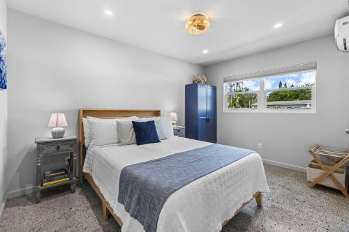a bedroom with a large bed and a blue refrigerator at Neptunes Hideaway in Vero Beach
