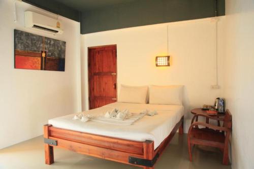 a bedroom with a bed with birds on it at Hometel Hotel in Krabi