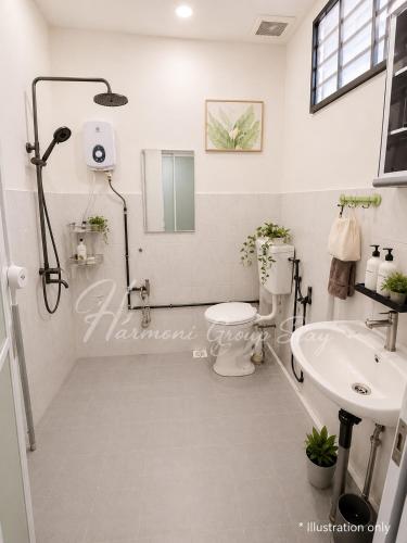 a bathroom with a shower and a toilet and a sink at Harmoni Group Stay in Bintulu