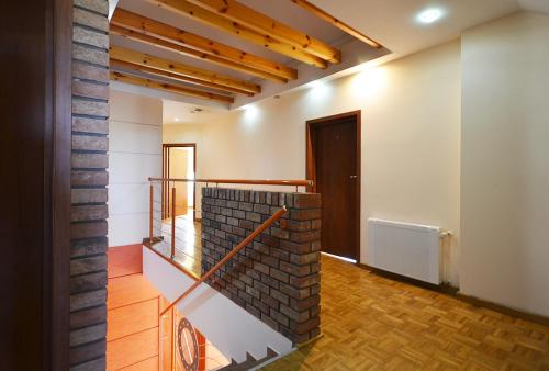 an empty room with a brick wall and a door at Villa Cis in Darłowo